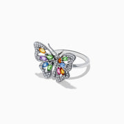 The Watercolors 14K Gold Multi Sapphire and Diamond Butterfly Ring features a silver butterfly with diamond-accented wings and colorful orange, green, blue, and purple sapphires at the center. Shown on a white background.
