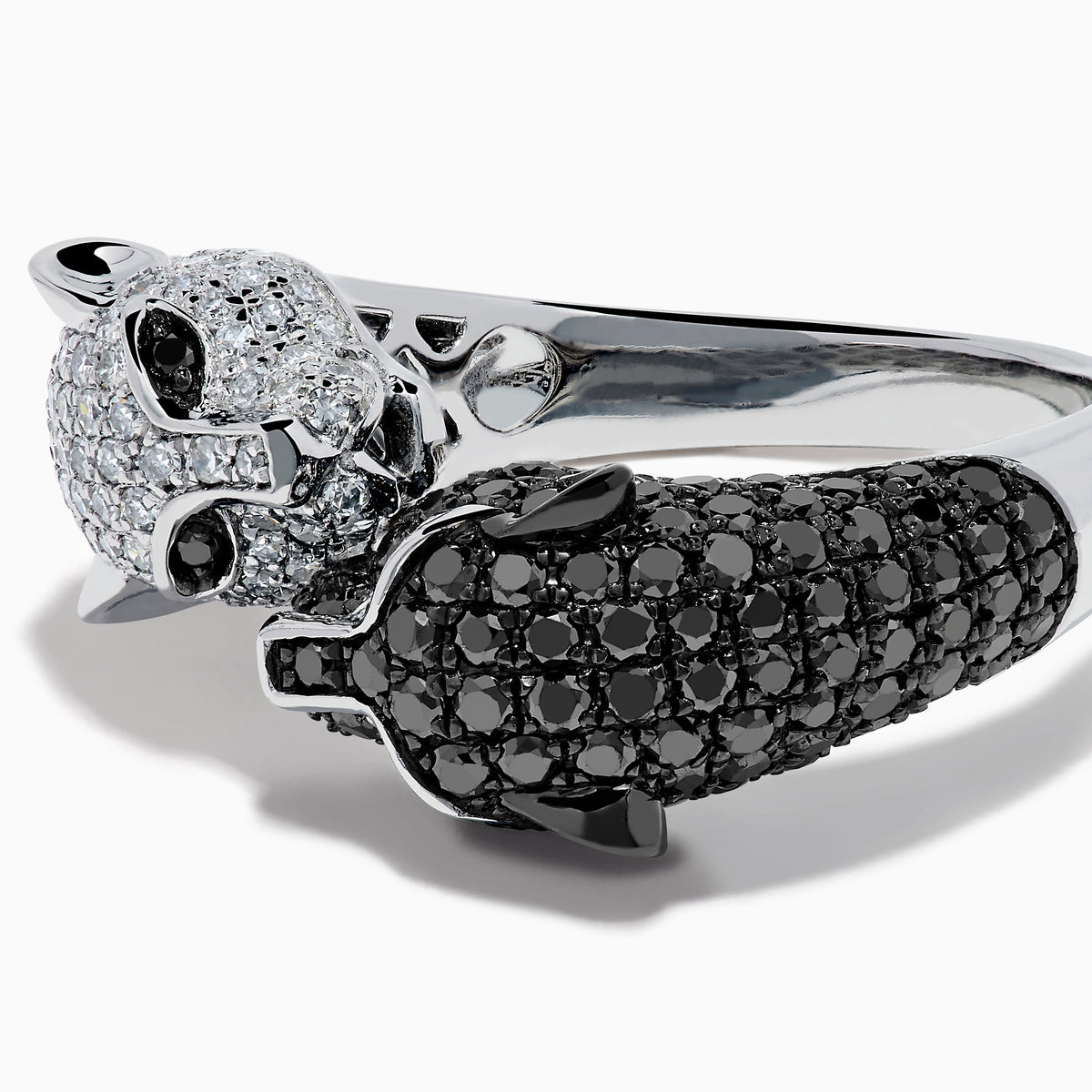 The Signature 14K White and Black Diamond Panther Bypass Ring features a panther head with black diamonds and a body with sparkling white diamonds, elegantly wrapping around the finger for a bold, contrasting look.