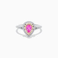 The 14K Two Tone Gold Pink Sapphire and Diamond Halo Ring showcases a pear-shaped pink sapphire center, double diamond halo with gold accents, and extra diamonds set along its two tone gold band.