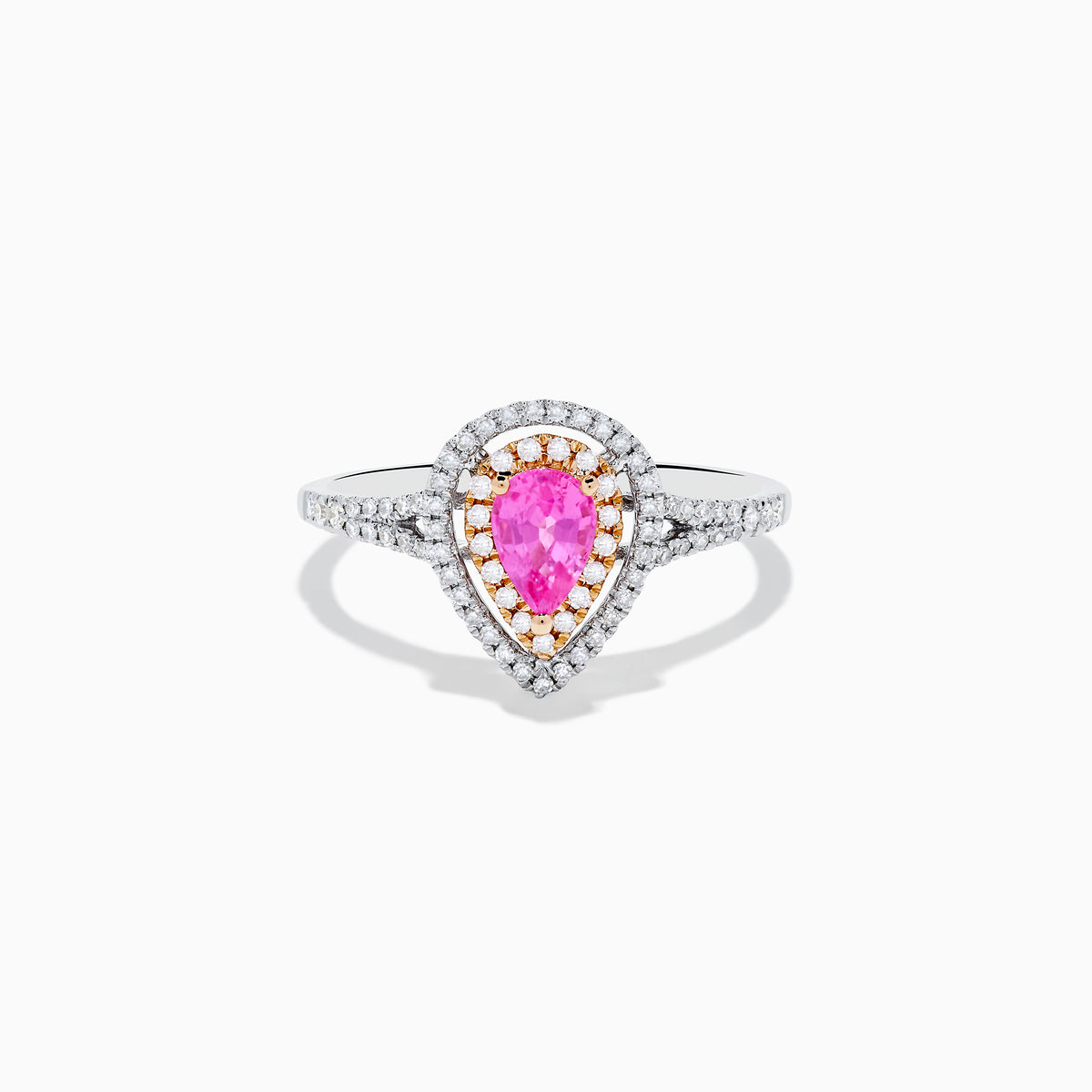 The 14K Two Tone Gold Pink Sapphire and Diamond Halo Ring showcases a pear-shaped pink sapphire center, double diamond halo with gold accents, and extra diamonds set along its two tone gold band.