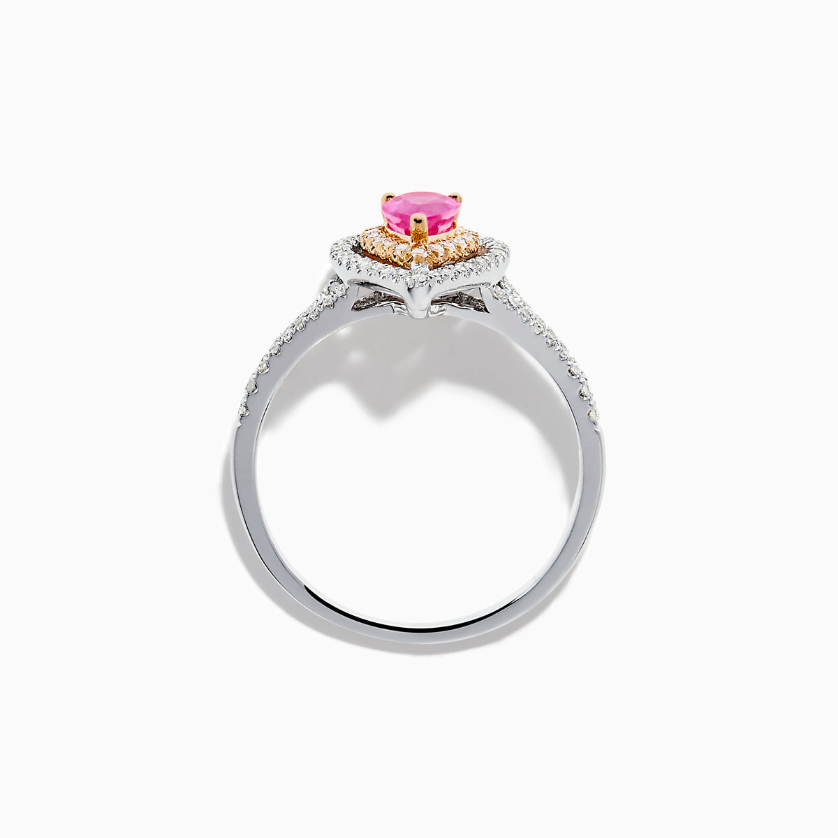 The 14K Two Tone Gold Pink Sapphire and Diamond Halo Ring showcases a pear-shaped pink sapphire center, double diamond halo with gold accents, and extra diamonds set along its two tone gold band.