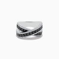 The 14K White Gold Black and White Diamond Crossover Ring features intersecting bands set with rectangular black and white diamonds, accented by rows of small clear stones for a striking crisscross effect.