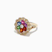 The Watercolors 14K Yellow Gold Multi Sapphire and Diamond Ring features a flower design with sapphire petals, a central white gemstone, and two diamond layers in a scalloped border.