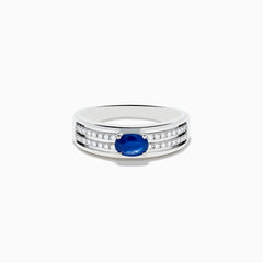 The 925 Sterling Silver Blue Sapphire and Diamond Ring showcases an oval blue sapphire centerpiece accented by two rows of sparkling round white diamonds along the band.