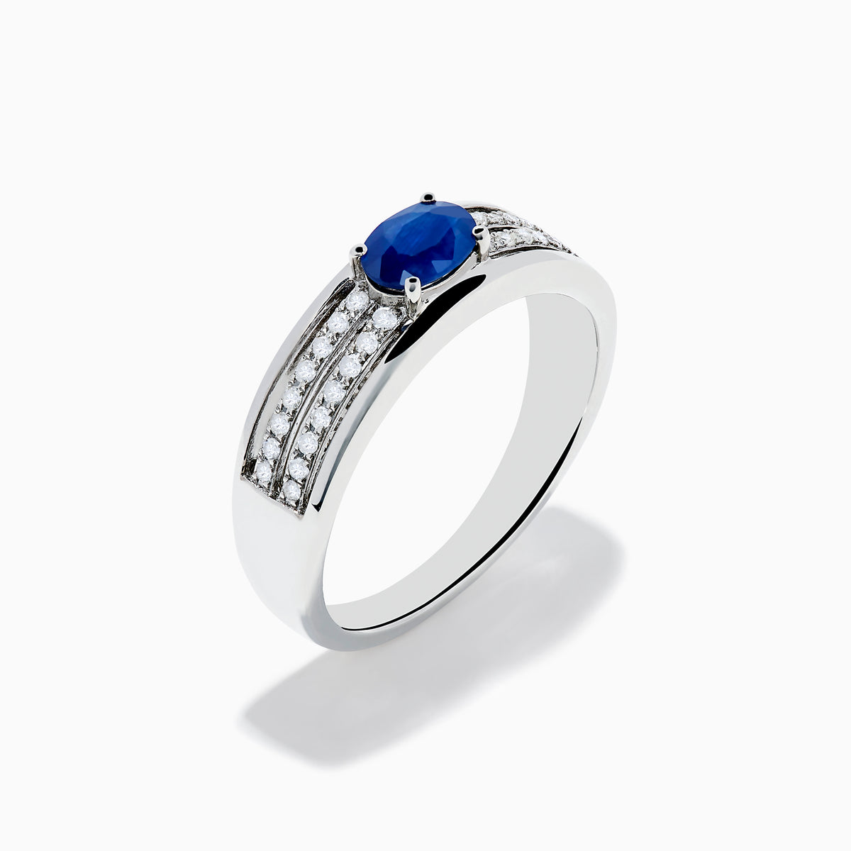 The 925 Sterling Silver Blue Sapphire and Diamond Ring showcases an oval blue sapphire centerpiece accented by two rows of sparkling round white diamonds along the band.