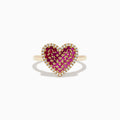 The Novelty 14K Yellow Gold Pink Sapphire, Ruby and Diamond Heart Ring features a heart-shaped design with central pink sapphire and ruby gemstones, surrounded by small white diamonds and shown on a white background.