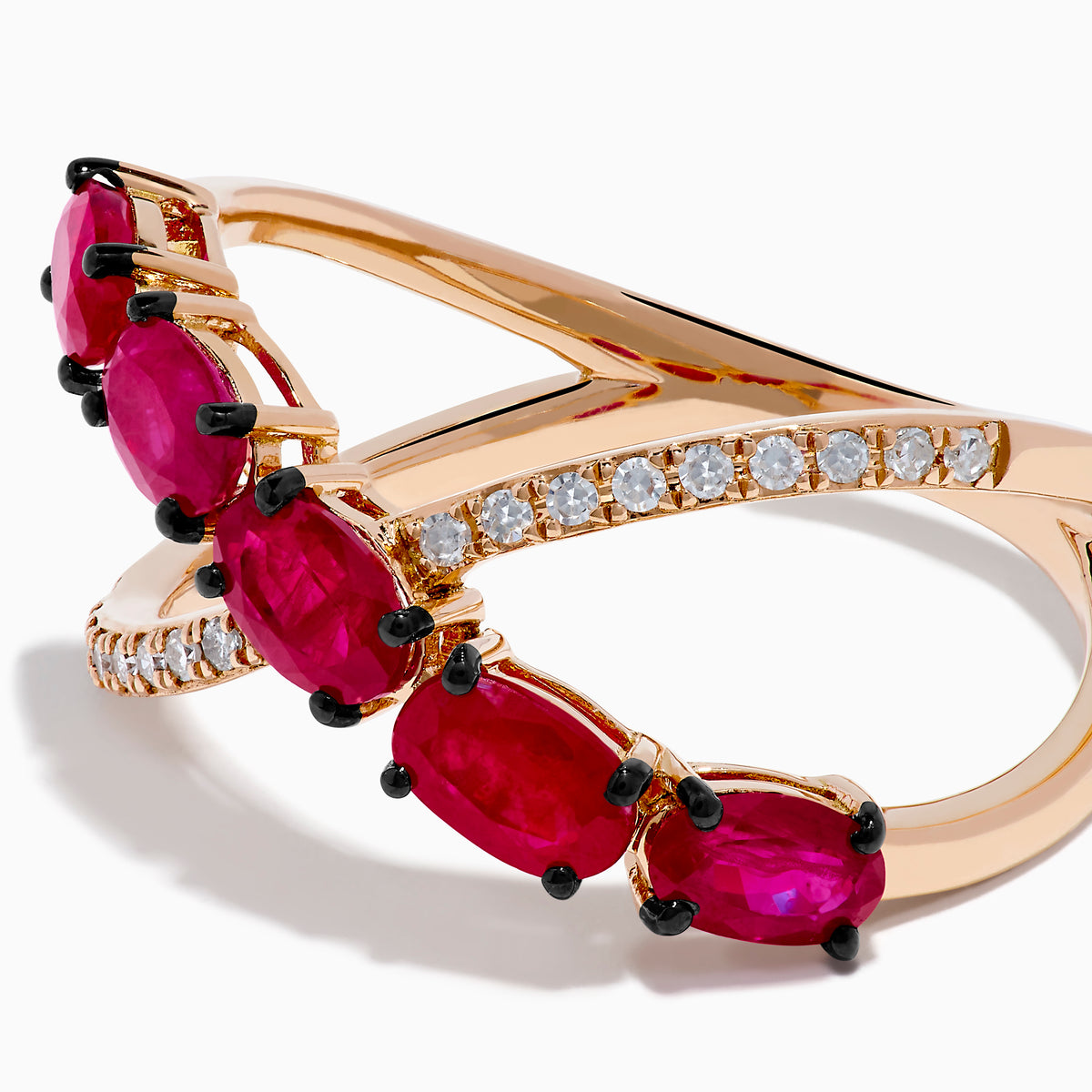 The 14K Rose Gold Diamond and Natural Ruby Criss Cross Ring features five oval red rubies on one band and small white diamonds on the other, set against a white background.