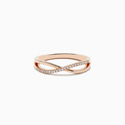 The Trio 14K 3-Tone Gold Diamond Stackable Crossover Rings Set of 3 features yellow, white, and rose gold bands, each with a crossover infinity design and sparkling diamond accents—perfect for stacking or wearing individually.