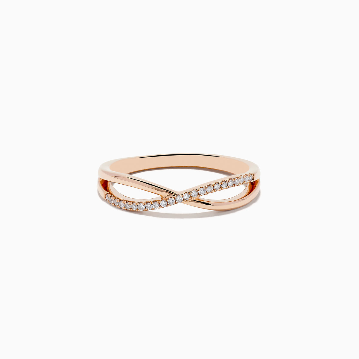 The Trio 14K 3-Tone Gold Diamond Stackable Crossover Rings Set of 3 features yellow, white, and rose gold bands, each with a crossover infinity design and sparkling diamond accents—perfect for stacking or wearing individually.