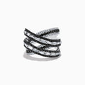 The 14K White Gold Black and White Diamond Criss Cross Ring features overlapping bands set with alternating rows of black and white diamonds for a striking, modern look.