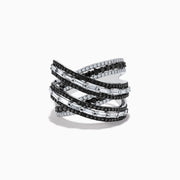 The 14K White Gold Black and White Diamond Criss Cross Ring features overlapping bands set with alternating rows of black and white diamonds for a striking, modern look.