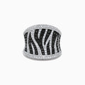 The 14K White Gold Black and White Diamond Zebra Print Ring features a striking zebra-striped pattern, with sparkling black and white diamonds set in a wide, slightly curved band for a bold, textured finish.