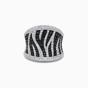 The 14K White Gold Black and White Diamond Zebra Print Ring features a striking zebra-striped pattern, with sparkling black and white diamonds set in a wide, slightly curved band for a bold, textured finish.