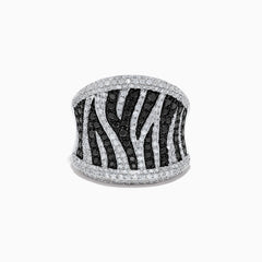 The 14K White Gold Black and White Diamond Zebra Print Ring features a striking zebra-striped pattern, with sparkling black and white diamonds set in a wide, slightly curved band for a bold, textured finish.
