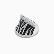 The 14K White Gold Black and White Diamond Zebra Print Ring features a striking zebra-striped pattern, with sparkling black and white diamonds set in a wide, slightly curved band for a bold, textured finish.
