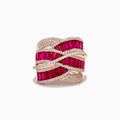 The Ruby Royale 14K Rose Gold Ruby and Diamond Cocktail Ring showcases alternating rows of vibrant rubies and sparkling diamonds in a wavy, interwoven design, set beautifully against a white background.