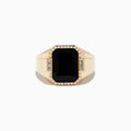 The Mens 14K Yellow Gold Onyx and Diamond Ring showcases a large rectangular onyx centerpiece framed by round diamonds, accented with two baguette-cut clear stones on each side.