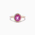 The 14K Rose Gold Pink Sapphire and Diamond Double Halo Ring features an oval pink sapphire center, double halo of clear diamonds, and a slim band with additional diamonds, shown on a white background.