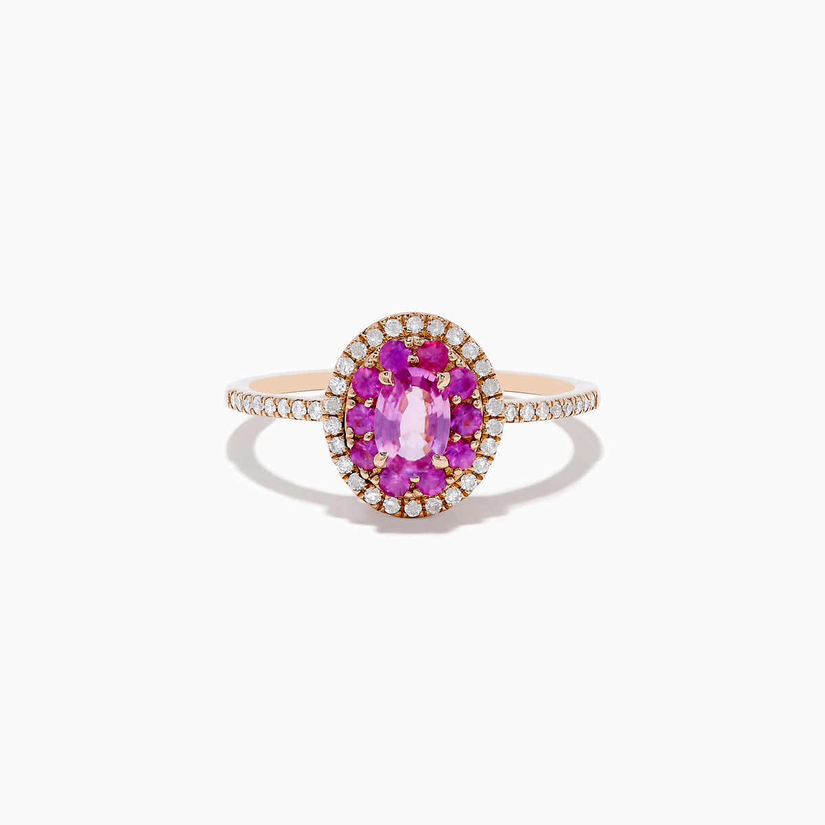 The 14K Rose Gold Pink Sapphire and Diamond Double Halo Ring features an oval pink sapphire center, double halo of clear diamonds, and a slim band with additional diamonds, shown on a white background.