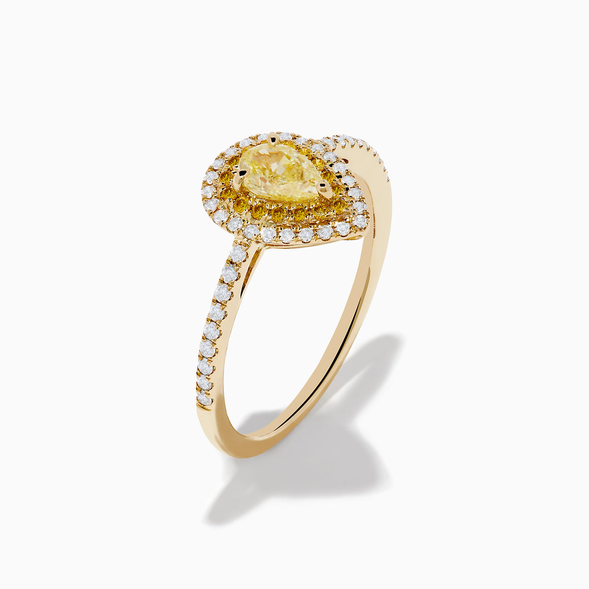 The Canare 14K Yellow Gold White and Yellow Diamond Ring features a pear-shaped yellow diamond with a white diamond halo and diamond-accented band, shown on a white background.