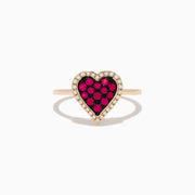 The Novelty 14K Rose Gold Ruby and Diamond Heart Ring features a heart-shaped centerpiece with red rubies surrounded by small clear diamonds, shown against a plain white background.