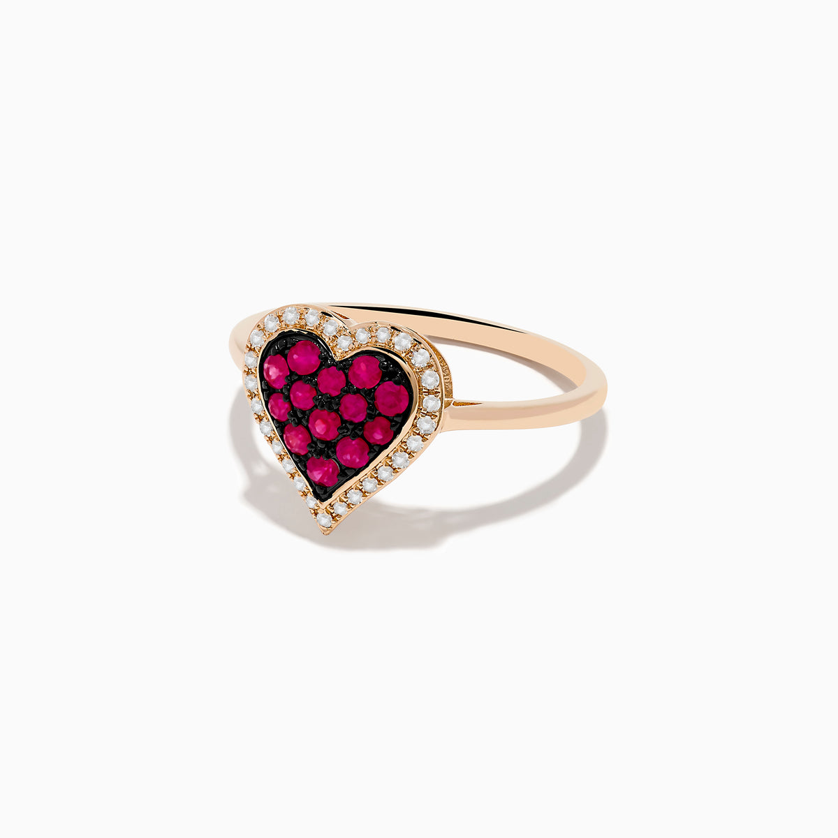 The Novelty 14K Rose Gold Ruby and Diamond Heart Ring features a heart-shaped centerpiece with red rubies surrounded by small clear diamonds, shown against a plain white background.