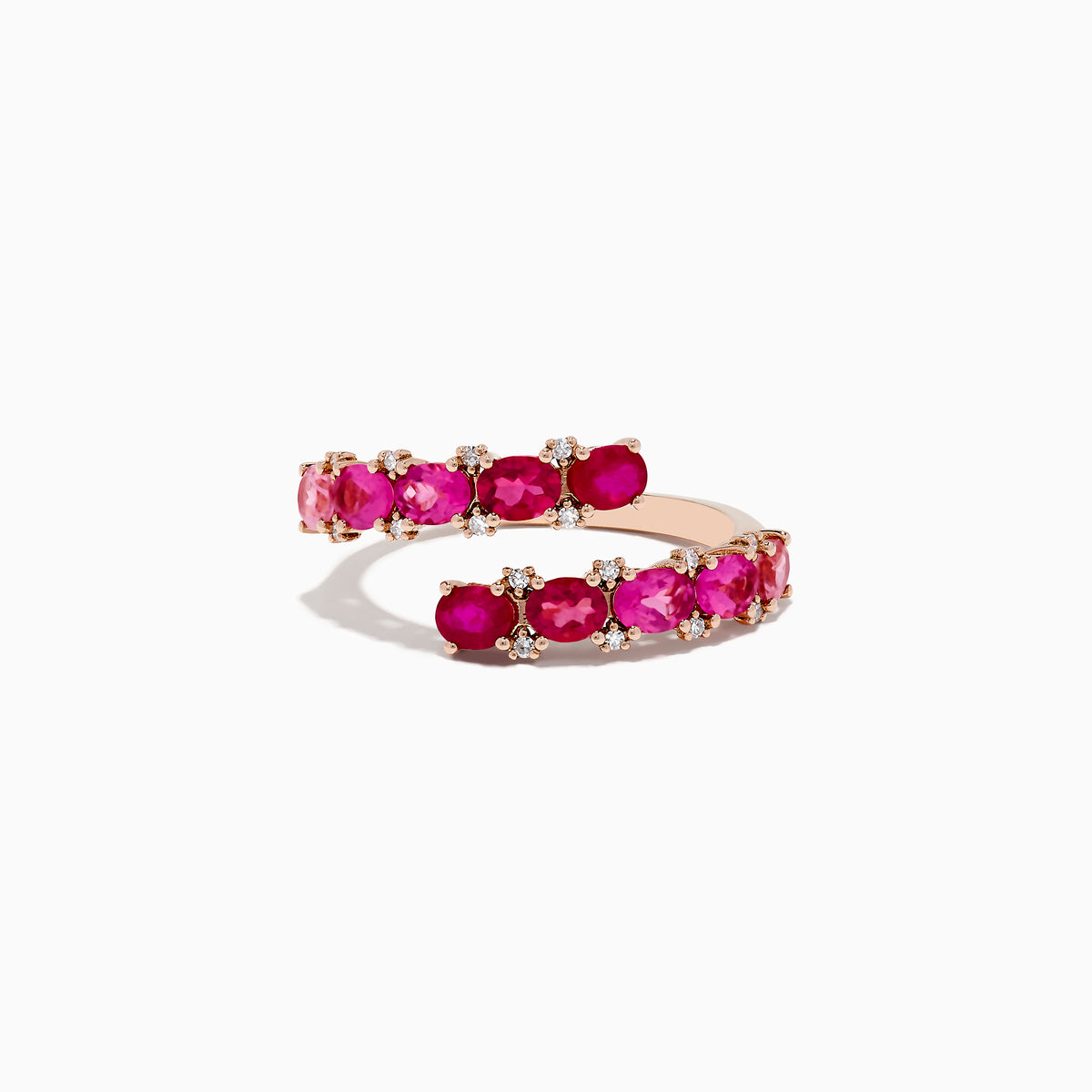 Crafted in 14k rose gold, this bypass ring showcases pink tourmaline and rubies totaling 1.49 TCW, accented by white diamonds in a spiral design.