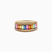 The Watercolors 14K Yellow Gold Multi Sapphire and Diamond Ring showcases vibrant sapphires in various hues bordered by two rows of sparkling diamonds, all set on a yellow gold band and displayed against a white background.