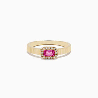 The 14K Yellow Gold Pink Sapphire and Diamond Ring features a ribbed gold band, a rectangular pink sapphire centerpiece, and a halo of white diamonds, shown on a white background.