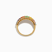 The Watercolors 14K Yellow Gold Multi Sapphire Baguette Band Ring showcases a row of rectangular rainbow sapphires, bordered by small round clear stones for a vibrant, elegant look.