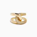The D'Oro 14K Yellow Gold Diamond Interlocking Ring features a knot design, with one section accented by sparkling diamonds, beautifully displayed against a white background.