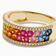 The Watercolors 14K Yellow Gold Multi Sapphire and Diamond Band showcases a central rainbow gradient of sapphires bordered by two rows of white diamonds, set in yellow gold and displayed on a white background.