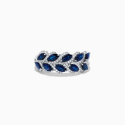 The 14K White Gold Sapphire and Diamond Leaf Motif Ring features alternating marquise-shaped blue sapphires and small round diamonds arranged in a woven, leaf-like design.