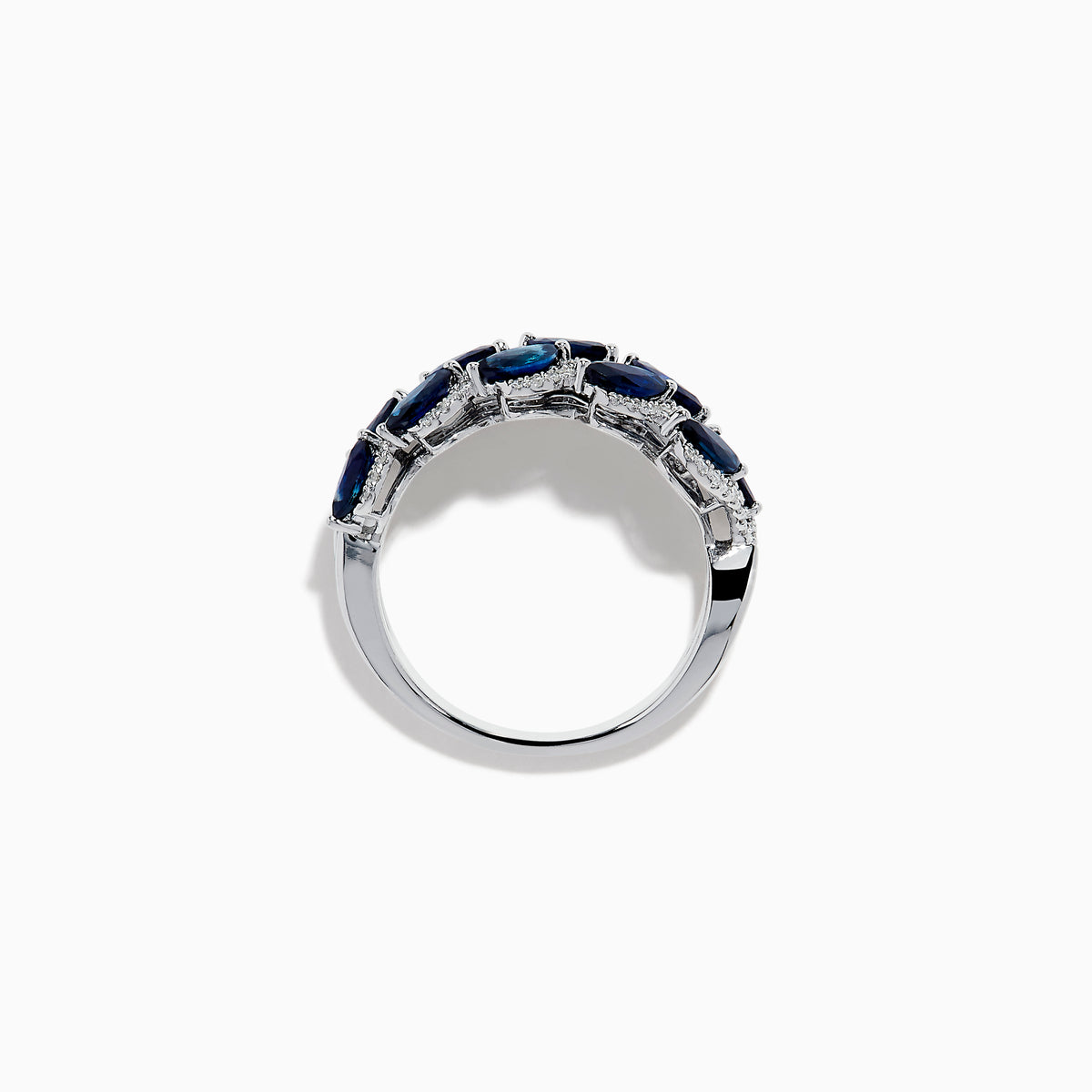 The 14K White Gold Sapphire and Diamond Leaf Motif Ring features alternating marquise-shaped blue sapphires and small round diamonds arranged in a woven, leaf-like design.