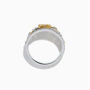 This 14K two tone gold flower ring features a wide band with a central cluster of yellow diamonds, surrounded by small white diamonds, and elegant gold and silver accents.