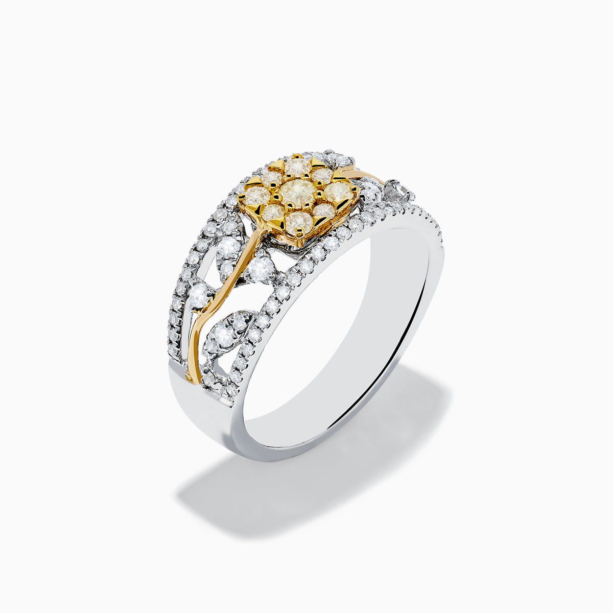 This 14K two tone gold flower ring features a wide band with a central cluster of yellow diamonds, surrounded by small white diamonds, and elegant gold and silver accents.