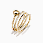 The D'Oro 14K Yellow Gold Spiral Diamond Ring features three bands, two adorned with sparkling diamonds. The top band forms a graceful circular loop, offering an elegant and modern touch.