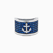 The Sterling Silver Blue Sapphire and Diamond Anchor Ring showcases a striking anchor center in clear stones, set on a white background with blue sapphires for added elegance.