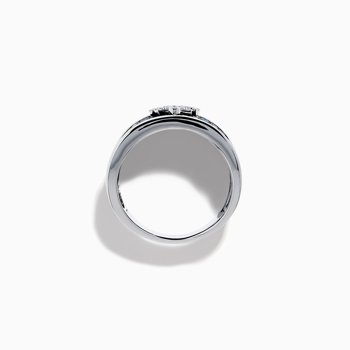 The Sterling Silver Blue Sapphire and Diamond Anchor Ring showcases a striking anchor center in clear stones, set on a white background with blue sapphires for added elegance.