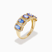 The 14K Yellow Gold Tanzanite and Diamond Halo Band showcases five rectangular tanzanites, each framed by a sparkling diamond halo, creating an elegant continuous design.