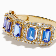 The 14K Yellow Gold Tanzanite and Diamond Halo Band showcases five rectangular tanzanites, each framed by a sparkling diamond halo, creating an elegant continuous design.