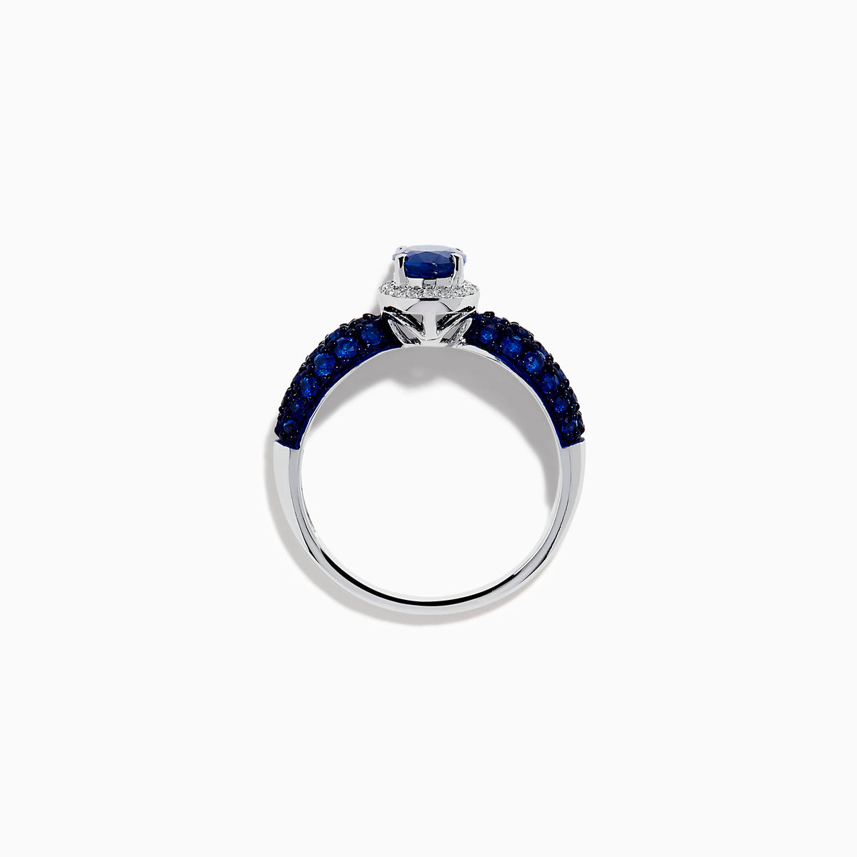 The 14K White Gold Blue Sapphire and Diamond Ring showcases a striking oval blue sapphire center, surrounded by sparkling diamonds, with additional sapphires set along the band.