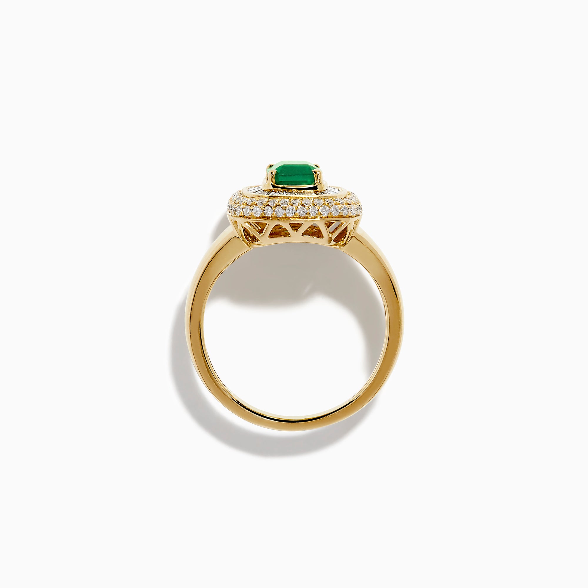 The 14K Yellow Gold Emerald and Diamond Double Halo Ring features an emerald-cut green gemstone at the center, framed by two rows of round and baguette diamonds in a rectangular halo setting.