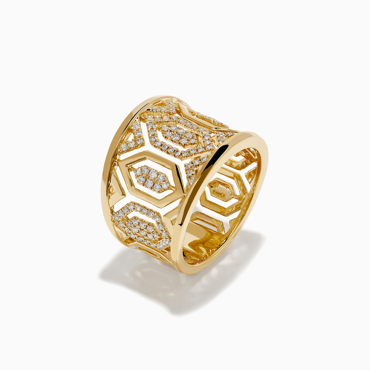 The D'Oro 14K Yellow Gold Geometric Diamond Ring features a wide band with intricate geometric patterns set with sparkling white diamonds, offering an ornate and luxurious look.