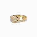 The Signature 14K Yellow Gold Diamond Panther Ring features a panther’s head with diamond accents, green gemstone eyes, black detailing, and a ring held in its mouth.