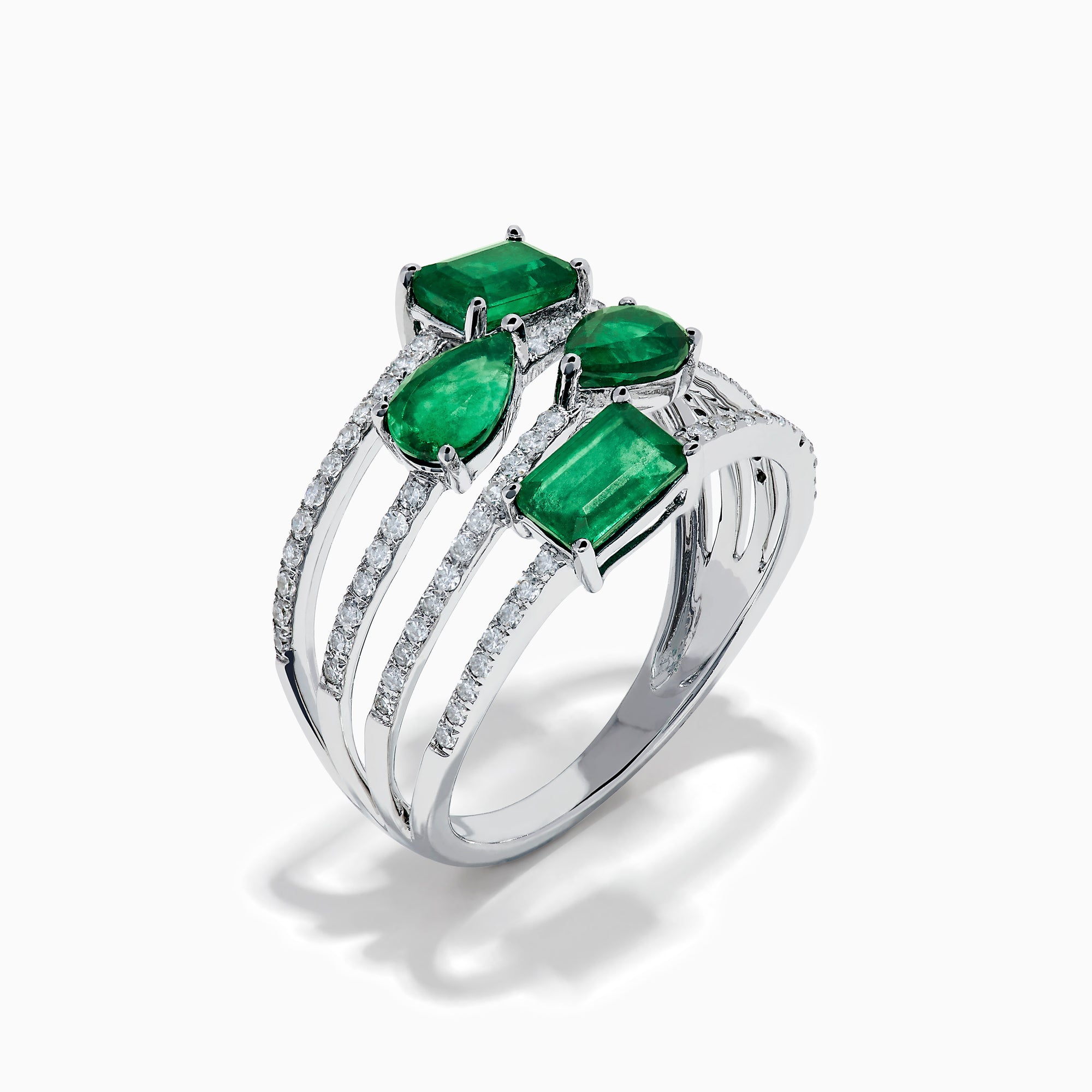 The 14K White Gold Emerald and Diamond Open Multi Row Ring showcases three bands set with diamonds and accented by large rectangular, square, and teardrop-shaped emeralds for a dazzling effect.
