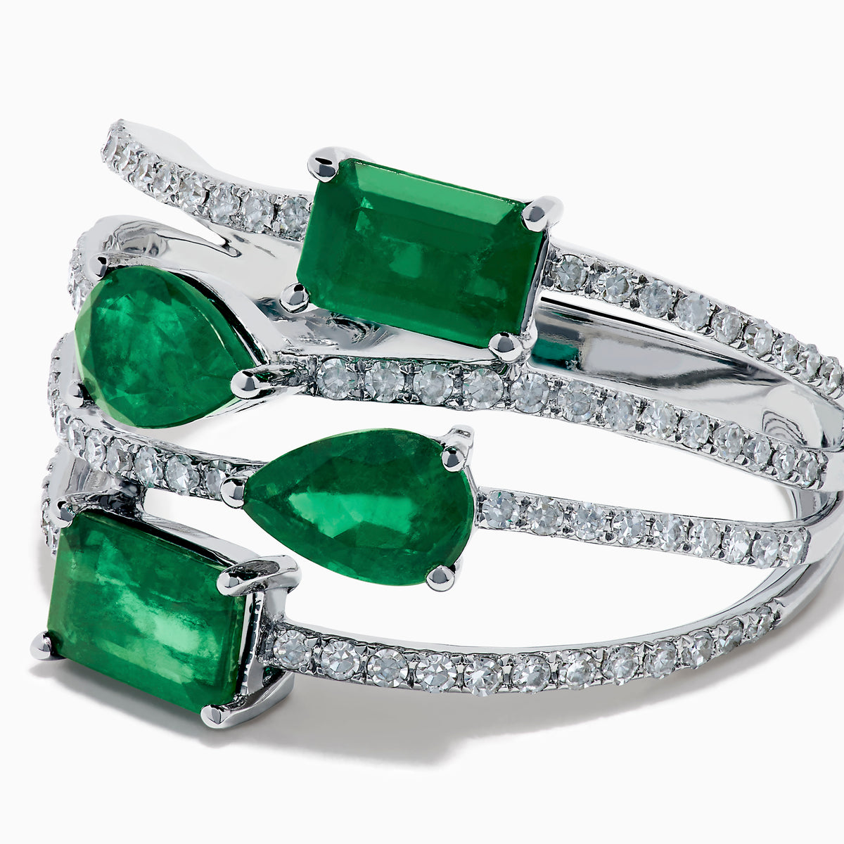 The 14K White Gold Emerald and Diamond Open Multi Row Ring showcases three bands set with diamonds and accented by large rectangular, square, and teardrop-shaped emeralds for a dazzling effect.