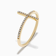 The Novelty 14K Yellow Gold Diamond Cross Ring features a large horizontal cross design set with small white diamonds, showcased on a plain white background. A stunning statement piece for any occasion.