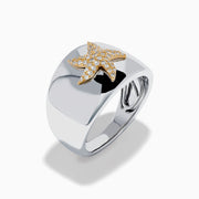 The Sterling Silver and 14K Yellow Gold Plated Diamond Starfish Ring showcases a gold-plated starfish adorned with sparkling white stones, set on a wide sterling silver band and displayed against a plain white background.