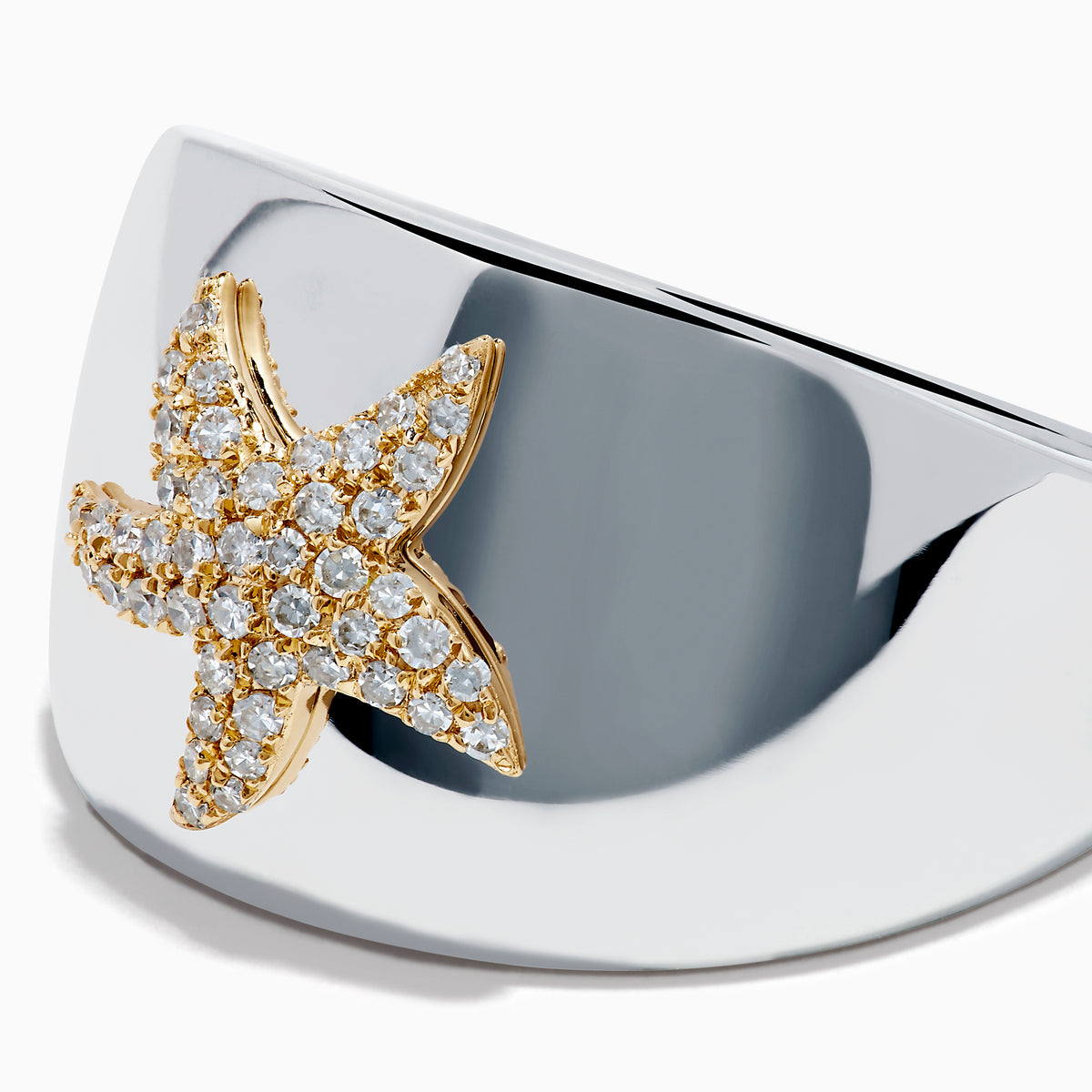 The Sterling Silver and 14K Yellow Gold Plated Diamond Starfish Ring showcases a gold-plated starfish adorned with sparkling white stones, set on a wide sterling silver band and displayed against a plain white background.